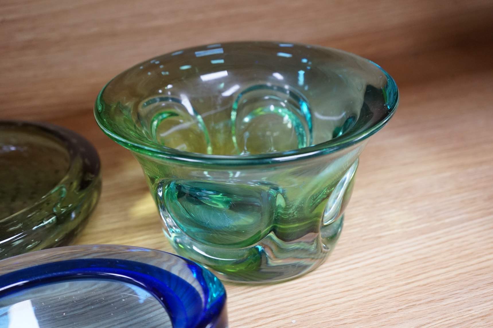 A Whitefriars green glass ‘bubble’ dish, a Costa Boda blue/green bowl and a Murano dish (3) tallest 10.5cm